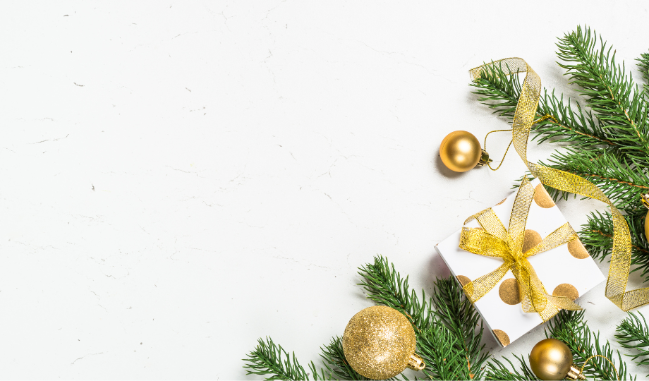 Gold ornaments and greenery against a white background to promote Holiday Loans.