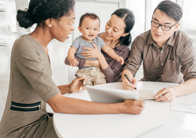 A family sitting around a table with a baby